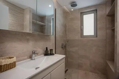 a bathroom with a sink and a shower at Casadi City Apartment in Rhodes Town