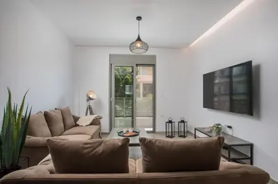 a living room with two couches and a table at Casadi City Apartment in Rhodes Town