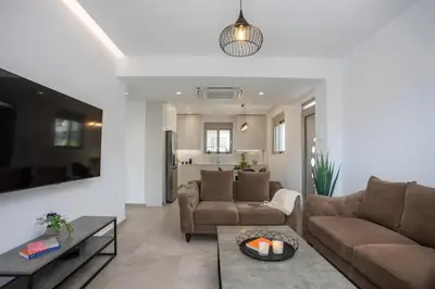a living room with a couch and a table at Casadi City Apartment in Rhodes Town