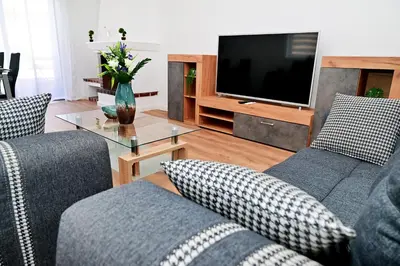 a living room with two couches and a television at Dionysus Apartment in Rhodes Town