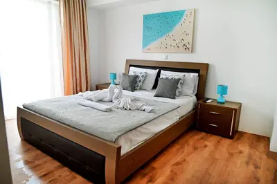 a bedroom with a bed with two towels on it at Dionysus Apartment in Rhodes Town
