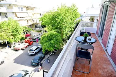 a balcony with a table and chairs and a street at Dionysus Apartment in Rhodes Town