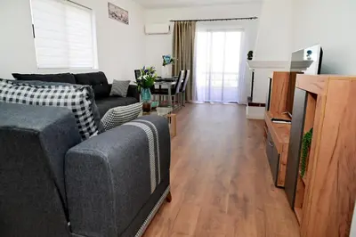 a living room with a couch and a tv at Dionysus Apartment in Rhodes Town