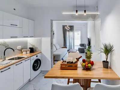a kitchen with a table with a bowl of fruit on it at Sunny Nest Apartments in Ixia