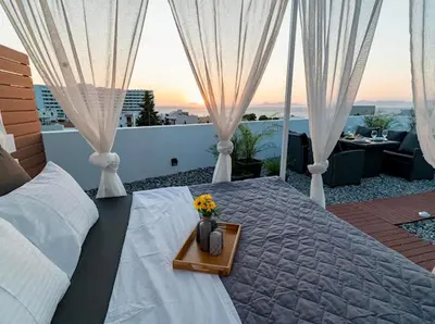 a bedroom with a bed with a tray with flowers on it at Sunny Nest Apartments in Ixia