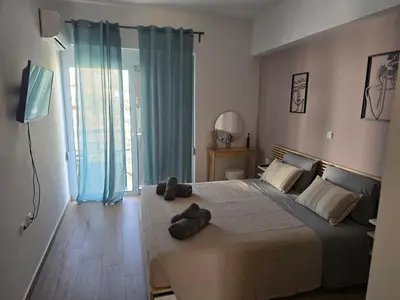 a bedroom with a large bed with two stuffed animals on it at The cozy nest in Rhodes in Rhodes Town