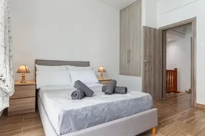 a bedroom with a large bed with two pillows on it at Casa Aurora Rhodes in Rhodes Town