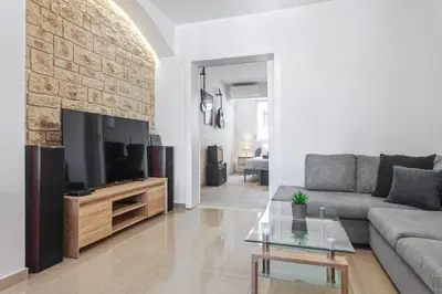 a living room with a couch and a flat screen tv at Casa Aurora Rhodes in Rhodes Town