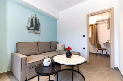 a living room with a couch and a table at Haraki Bliss in Haraki