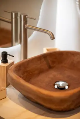 a wooden sink with a metal faucet in a bathroom at Haraki Bliss in Haraki
