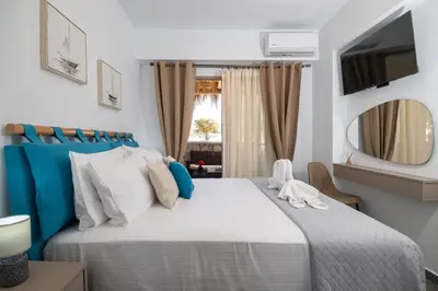 a bedroom with a large bed and a window at Haraki Bliss in Haraki
