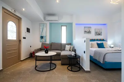 a bedroom with a bed and a couch and a table at Haraki Bliss in Haraki