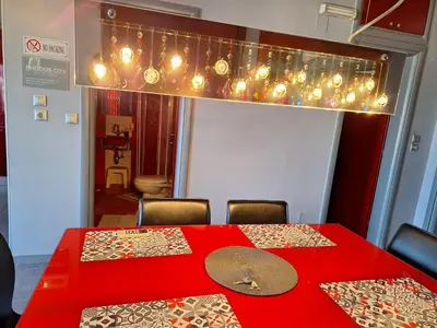 a red table with chairs and a red table with lights at Rhodos City in Rhodes Town