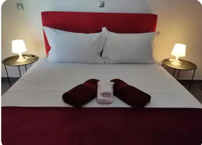 a bedroom with a bed with two towels on it at Rhodos City in Rhodes Town