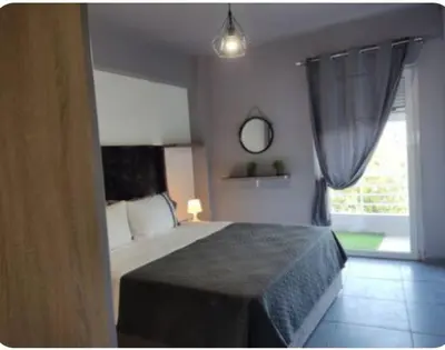 a bedroom with a large bed and a window at Rhodos City in Rhodes Town