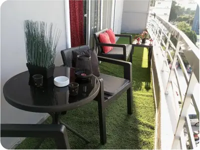 a table and chairs on a balcony with plants at Rhodos City in Rhodes Town