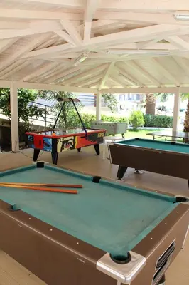 two ping pong tables in a pavilion with at Sea Melody Beach Hotel Apartments in Ialyssos