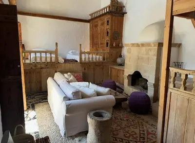 a living room with a couch and a fireplace at Villa Kali in Líndos
