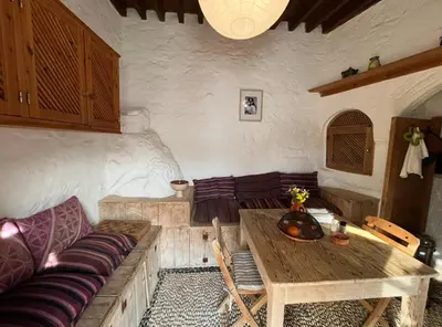 a living room with a couch and a wooden table at Villa Kali in Líndos