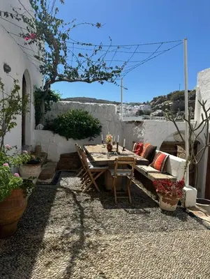 a patio with a couch and a table and chairs at Villa Kali in Líndos