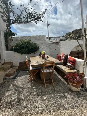 a wooden table and a bench in a yard at Villa Kali in Líndos