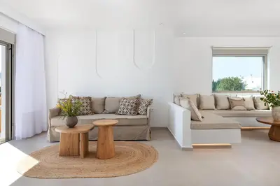 a living room with a couch and a table at Paradiso Luxury Beachfront Villa in Gennadi