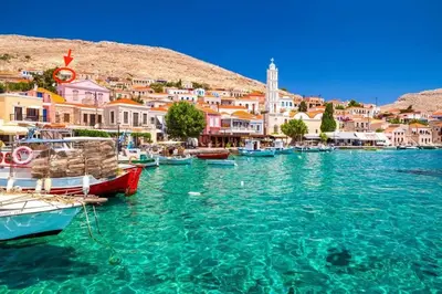 a group of boats in a body of water with buildings at Villa Panorama in Halki