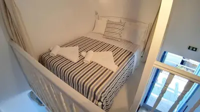 a small bed with two pillows on top of it at Villa Panorama in Halki