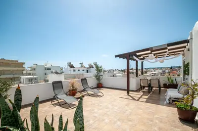 a patio with chairs and a table on a roof at Luna Loft in Rhodes Town