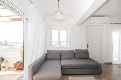 a living room with a couch and a window at Luna Loft in Rhodes Town