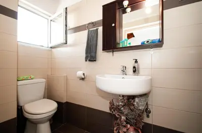 a bathroom with a sink and a toilet and a mirror at Luna Loft in Rhodes Town