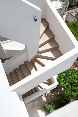 a white staircase with wooden treads at Luna Loft in Rhodes Town