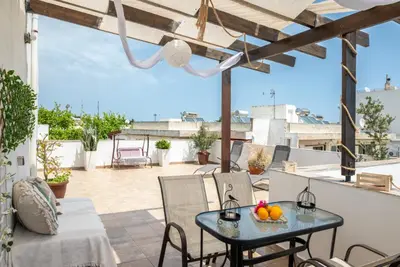a patio with a table and chairs on a balcony at Luna Loft in Rhodes Town
