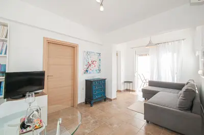 a living room with a couch and a tv at Luna Loft in Rhodes Town