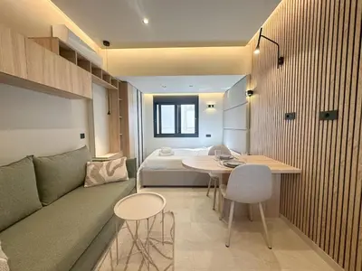 a room with a couch and a bed and a table at Anna Tiny Apartments in Rhodes Town