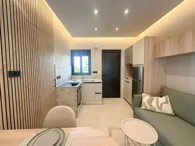 a kitchen with a couch and a table and chairs at Anna Tiny Apartments in Rhodes Town