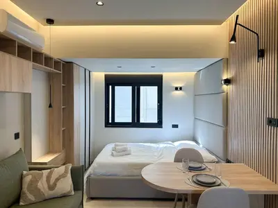 a small bedroom with a bed and a table at Anna Tiny Apartments in Rhodes Town