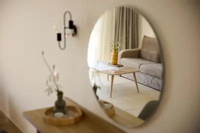 a living room with a couch and a mirror at Kiotari Miraluna Beach Resort in Kiotari