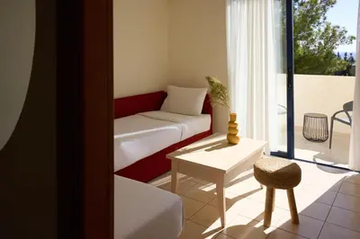a living room with a couch and a table at Kiotari Miraluna Beach Resort in Kiotari