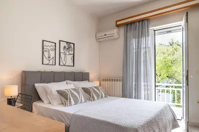 a bedroom with a large bed and a window at Maio Seaview & Sunset Stay in Kremasti Rhodes in Kremasti