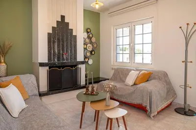 a living room with a couch and a fireplace at Maio Seaview & Sunset Stay in Kremasti Rhodes in Kremasti