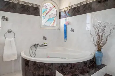 a bathroom with a bath tub with a window at Maio Seaview & Sunset Stay in Kremasti Rhodes in Kremasti