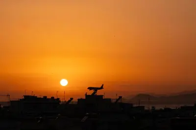 an airplane is sitting on the runway at sunset at Maio Seaview & Sunset Stay in Kremasti Rhodes in Kremasti