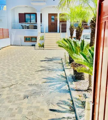 a house with palm trees in front of it at KIDONIA luxury villa in Archangelos