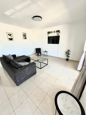 a living room with a couch and a table at KIDONIA luxury villa in Archangelos