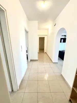 a hallway with white walls and a tile floor at KIDONIA luxury villa in Archangelos