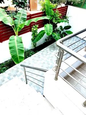 a set of stairs with green plants and a railing at KIDONIA luxury villa in Archangelos