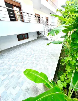 a courtyard of a white building with green plants at KIDONIA luxury villa in Archangelos