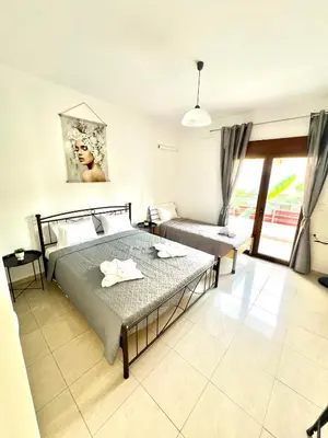 a bedroom with a large bed and a window at KIDONIA luxury villa in Archangelos
