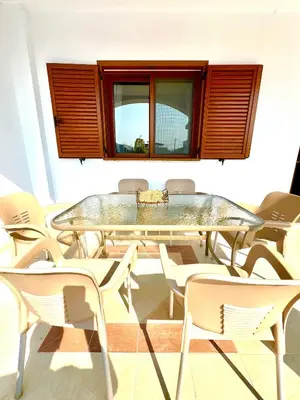 a glass table and chairs in a room at KIDONIA luxury villa in Archangelos